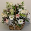 Arrangement includes snapdragons, roses, lilies, carnations, lilies, daisies, filler and assorted greenery