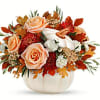 Elegant cr&egrave;me roses blend with the heartwarming hues of autumn in this