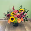 This gorgeous arrangement has stock, mini gerberas, sunflowers, calycium, mums, roses, hydrangeas