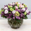 Standard size of this arrangement has roses lilacs and viburnum. Premium will
