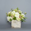 A mixture of green orchids, white hydrangea and locally available coordinating blooms