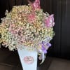 A tall arrangement filled with a bright colorful baby&#039;s breath wrapped in