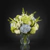 Clusters of blue and green hydrangea give this floral arrangement a fresh