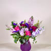 A charming and elegant floral arrangement designed in rich purple hues, perfect
