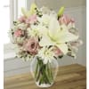 Lilies, roses &amp; assorted flowers designed in a garden vase