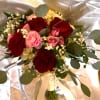 Sweetheart burgundy roses, pretty ranunculus, spray roses in cream and lavender, with