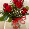 A classic design of six long-stemmed red roses arranged with million star