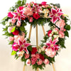 BEAUTIFUL OPEN HEART TRIBUTE STANDING SPRAY IN VARIETAL SHADES OF PINK. APPROXIMATELY