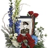 This bouquet features blue hydrangea, red roses, red spray roses, white spray
