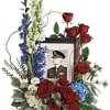 This bouquet features blue hydrangea, red roses, red spray roses, white spray
