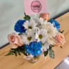 Elegant Mixed Bloom Arrangement

A clear glass vase cradles a lush and vibrant