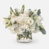 Elegant white roses and lisianthus nestled in lush clouds of hydrangeas, accented