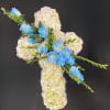 A cross form covered in white hydrangeas or carnations with a rose
