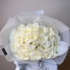 A bouquet of pristine white roses, embodying elegance and purity. Wrapped in
