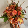 This vase arrangement has all the beautiful colors of fall.
Roses, carnations, protea