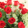 2 dozen red long stem roses with mixed greens in a clear