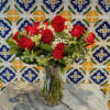 Share Joy Share flowers.
Beautiful red roses accented with some seasonal fresh foliage