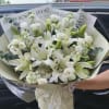 The product contains lily, roses, violet, and chrysanthemum, wrapped in paper. 