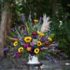 A one sided large scale basket of seasonal flowers to coordinate the