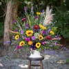 A one sided large scale basket of seasonal flowers to coordinate the