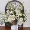 A collection of white and green flowers with faint blush accents in