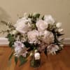 all white blooms, tightly bound in a slim vase. perfect gift for