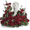 This breathtaking arrangement features a sea of rich red roses, symbolizing deep