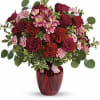 red roses and delicate pink alstroemeria are mixed with whimsical greens