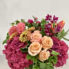 Lush arrangement of summer colors: orchids, roses, zinnias, hydrangea, tulips, and more!