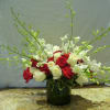 As Shown: 16 red and white roses and 10 orchid stems throughout