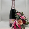 Beautiful adorned bottle of bubbles with flowers perfect to celebrate your love