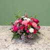 A charming seasonal arrangement presented in a keepsake teacup and saucer. Featuring