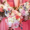 The &quot;Romance in Bloom&quot; bouquet artfully combines roses, carnations, and daisies with