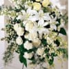 A MIXTURE OF WHITE FLOWERS ON AN EASEL 