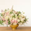 An exquisite arrangement of white dahlias,blush roses, soft pink spray roses, designed