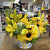 Medium round box with seasonal flowers in yellow colors