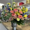 Beautiful and Delicate floral arrangement in spring colors!! Roses, chrysanthemums, alstroemerias, dolphins