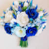 white roses, blue tulips, and green eucalyptus