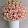 A luxurious arrangement filled with blush pink roses, artfully arranged in a