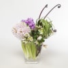 Bouquet of fragrant lilac accented with hellebores, lily grass and monkey tail