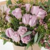 A gorgeous wrapped bouquet designed with premium 1 Dozen Lavender Roses, Wax
