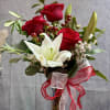 Three Red roses and a white lily , symbolizing love with timeless