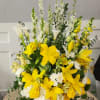 This thoughtful arrangement features radiant yellow lilies paired with elegant white flowers