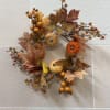 A fall wreath with pumpkins and leaves. 