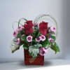 Recipe: Red Roses, Purple Chrysanthemums, and greens in a short, red vase.
Availability: