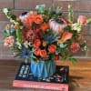 This exquisite arrangement captures the perfect blend of fall warmth and coastal