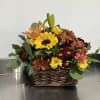 Gorgeous shades of fall. Sunflowers, lilies, spray roses, and assorted daisy poms.