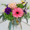 A bubble bowl filled with colorful roses and gerberas 