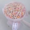 A full bouquet of roses in soft blush, nude, and peach tones