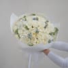 A soft and elegant bouquet of white roses and hydrangeas with delicate